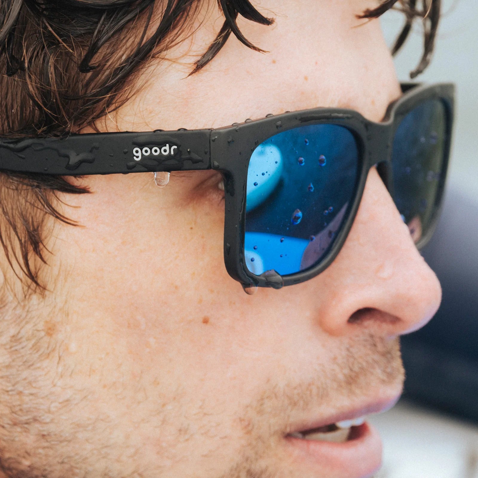 Black sunglasses with blue reflective lenses. Water repellent and capable of floating.